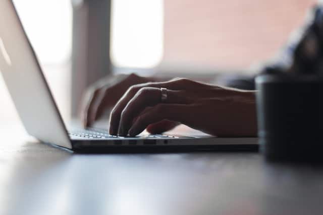 A Person searching for “same-day car title loans near me” on a laptop. 