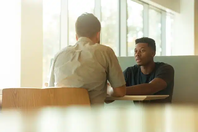 A loan applicant meeting with a provider to review the terms of a title loan in a professional setting.
