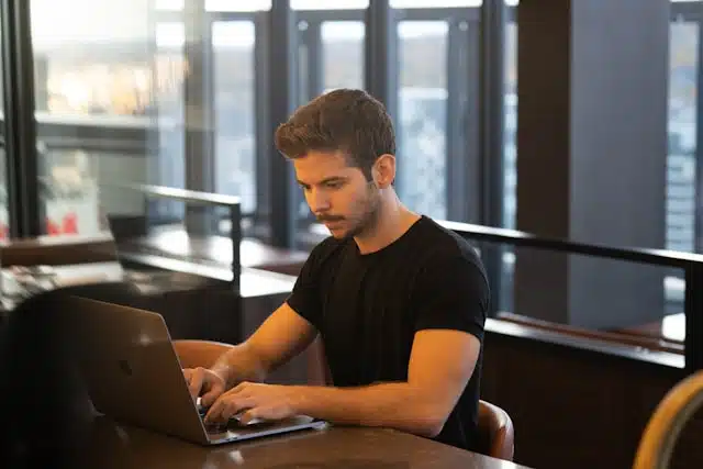 A man researching title loan options on his laptop.