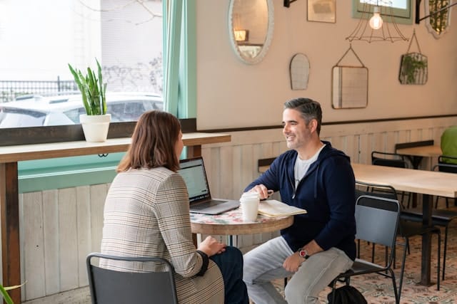 A title loan applicant discussing requirements with a loan provider in a relaxed setting.
